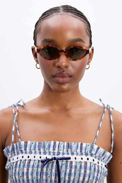 slim oval sunglasses with wavy temple in tort