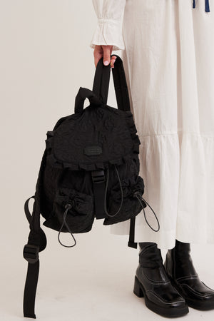 FRILL BACKPACK IN BLACK FLORAL STITCH