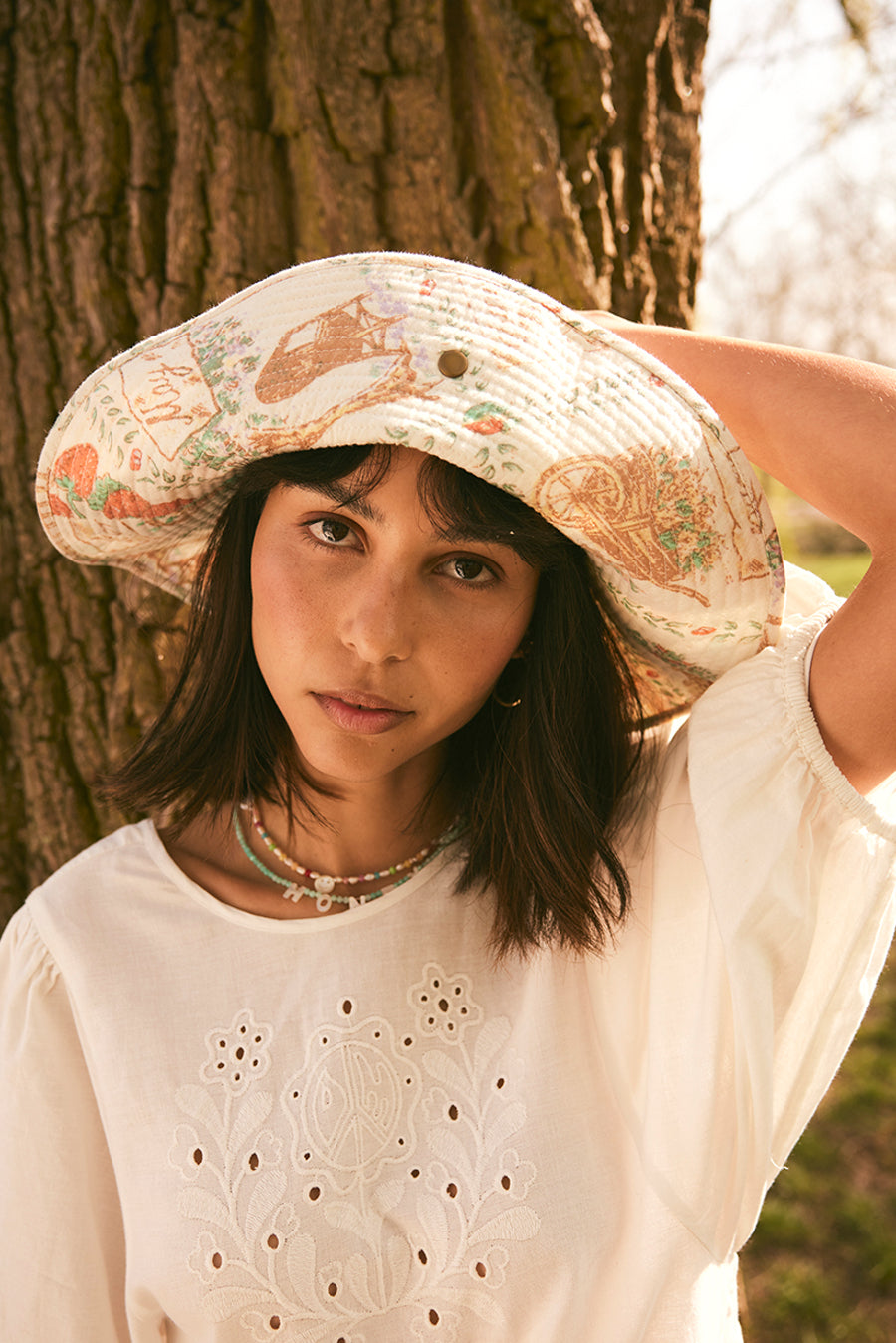 PADDED SUNHAT WITH POPPER IN TEA TOWL PRINT